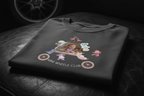 *A cinematic close-up shot of the 'Wheels Club' t-shirt folded neatly on a dark, textured leather surface. Soft, luxurious lighting highlights the premium fabric weave and the subtle, elegant 'Wheels Club' emblem. A blurred outline of a classic car wheel is in the background.*