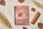 **Social Media Prompt:** An elegant, photorealistic flat lay shot designed for Instagram. The Celestial Aries journal is central. Arranged artfully around it are curated luxury items: a small gold constellation necklace, a raw piece of carnelian crystal, a premium leather pen sleeve, and dried botanical elements in warm autumnal tones. The surface is a clean, textured cream marble. The aesthetic is luxurious, organized, and aspirational.