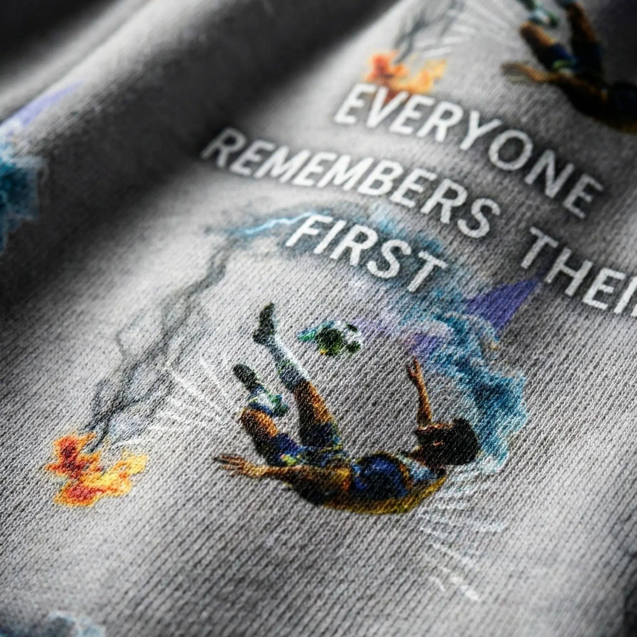 Detail of the soccer player figure and smoke effect print on the tracksuit.