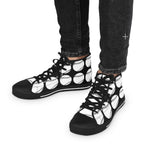 Patterned shoes on the feet of a person walking on a modern city street.