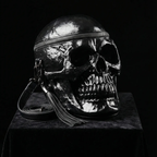 Skull bag illuminated with dramatic light against a completely black background.